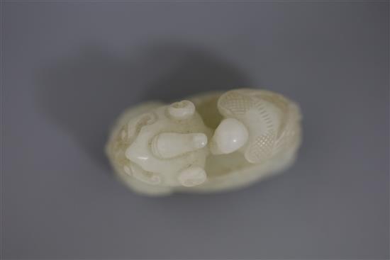 A Chinese white jade figure of bixi with a bird on its back, 17th/18th century, L. 5.4cm, wood stand